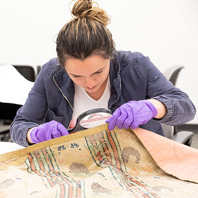 student looking through a magnifying glass